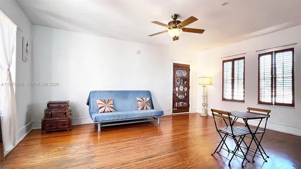 a living room with furniture and a wooden floor