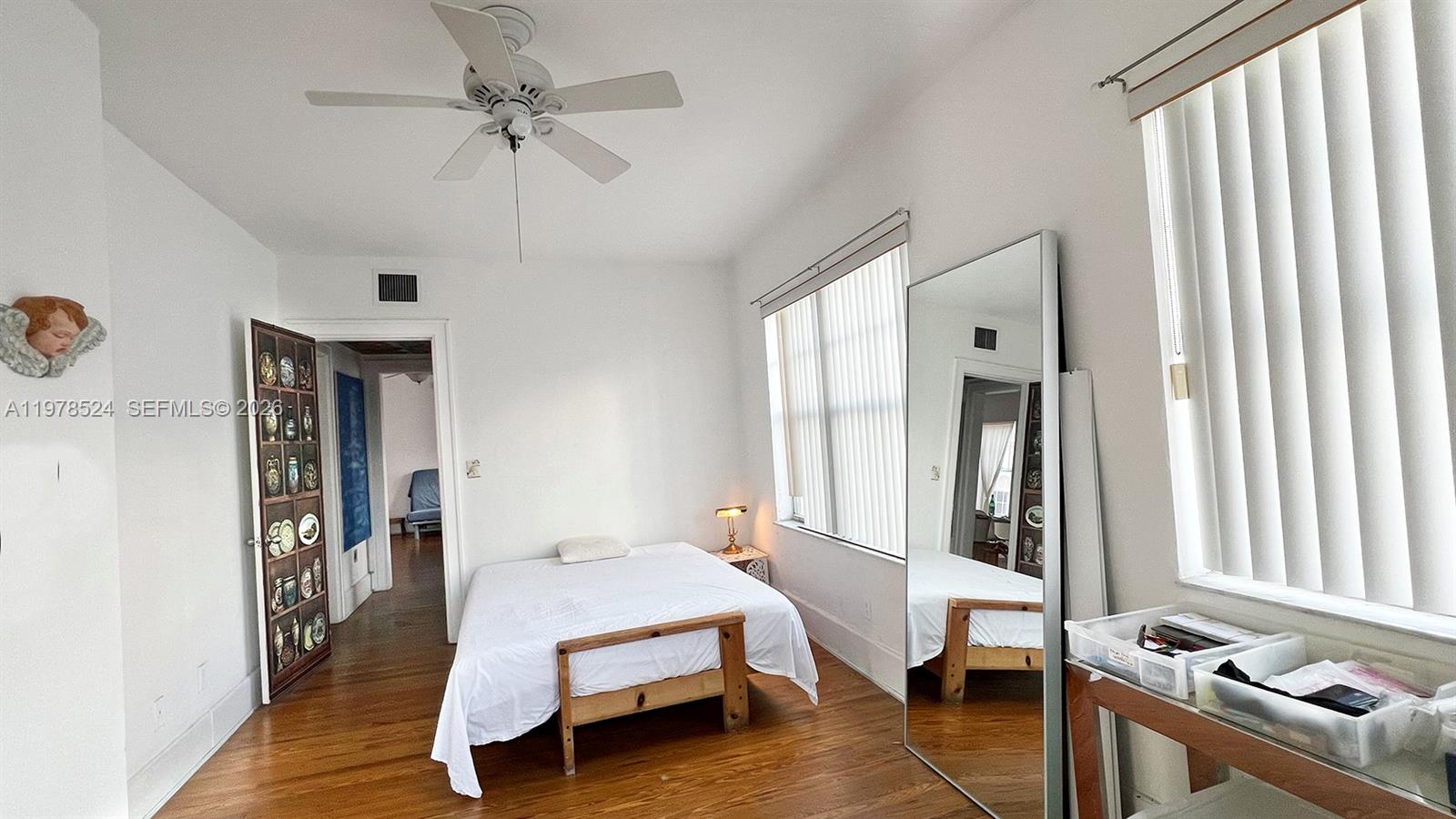 756 Meridian Avenue, Unit 10 Miami Beach, FL 33139 - Photo 6 of 9 a bed room with a bed and a chandelier