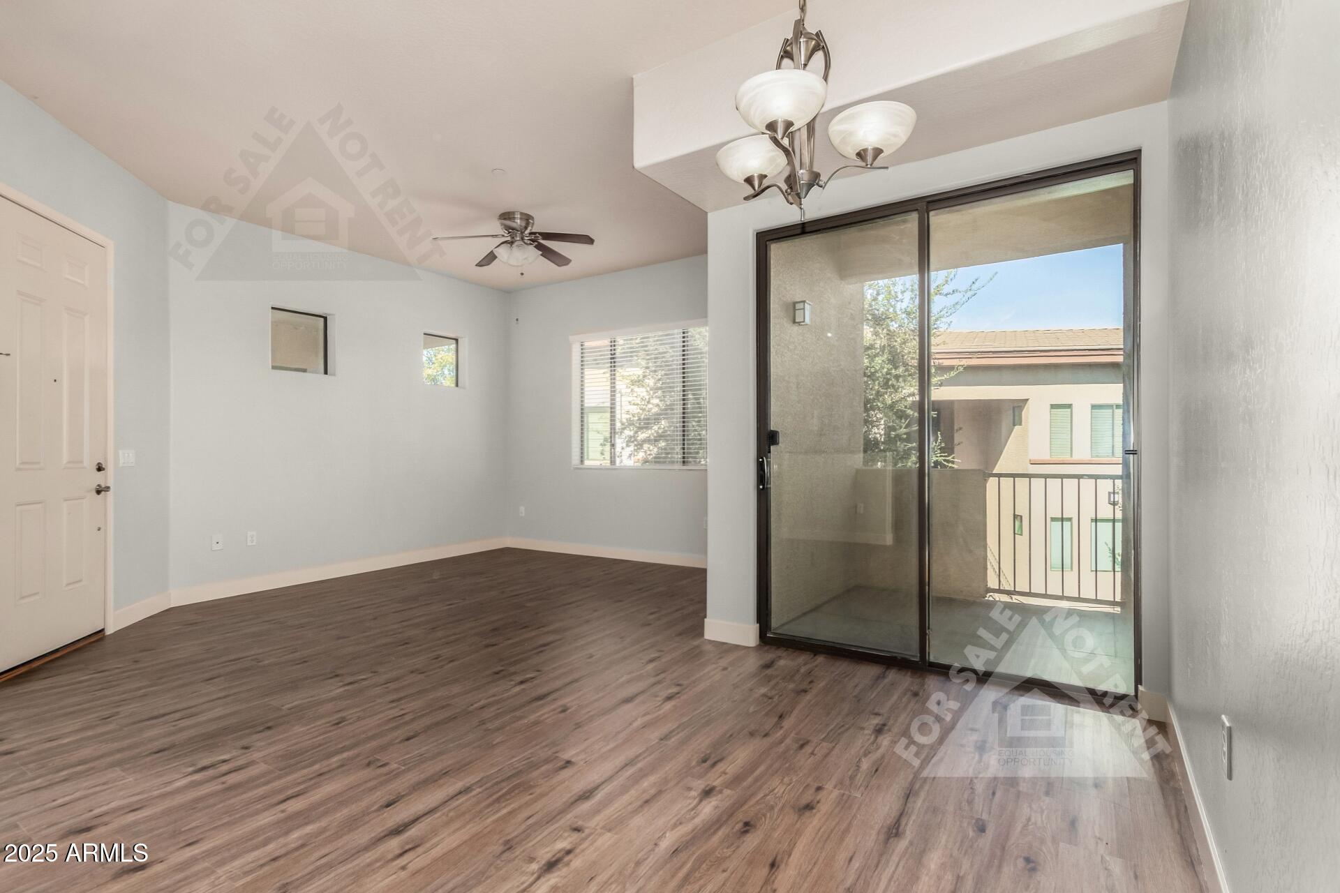 3330 South Gilbert Road, Unit 2008 Chandler, AZ 85286 - Photo 6 of 33 an empty room with wooden floor fan and windows