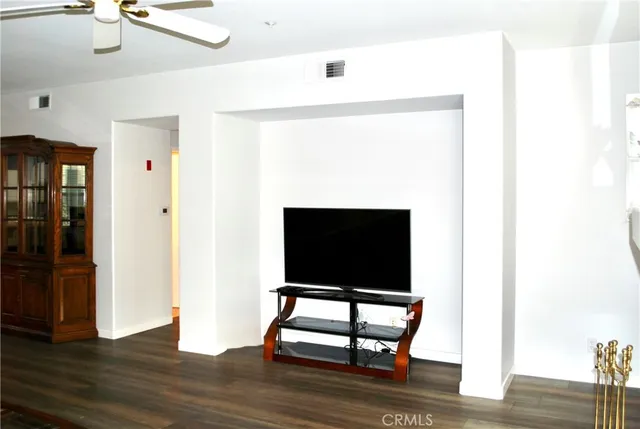 a living room with a flat screen tv and rug
