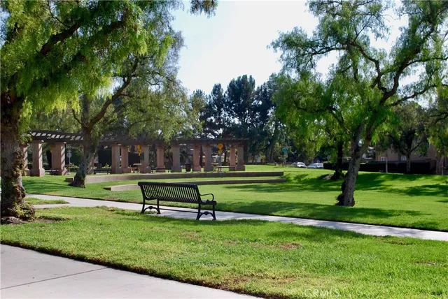 a front view of a house with a yard and palm trees