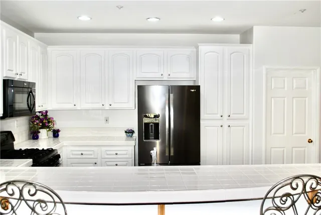 a kitchen with a refrigerator and cabinets