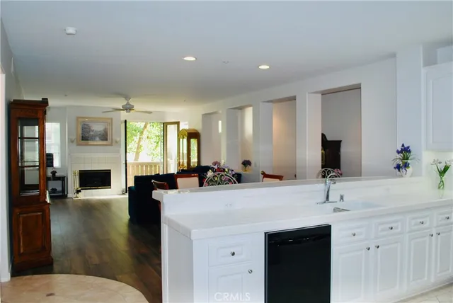 a view of living room with granite countertop a couch and wooden floor