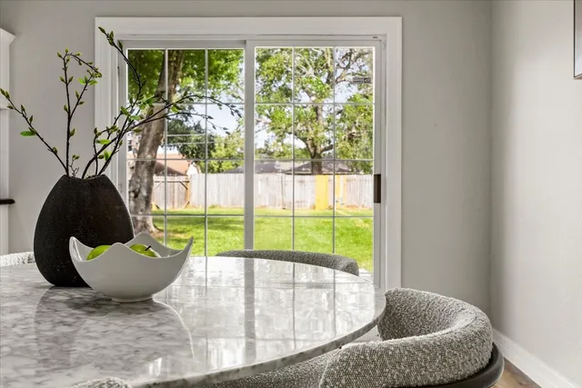 a view of empty room with wooden floor and ceiling fan