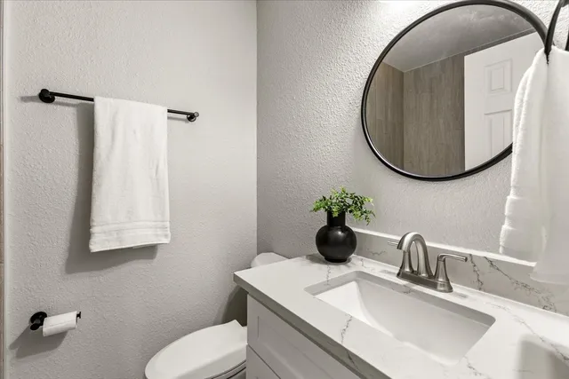 a bathroom with a shower curtain and a toilet