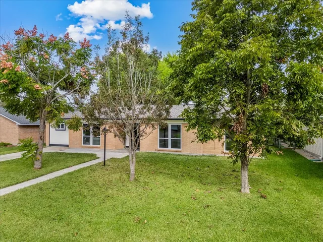a front view of house with yard and green space