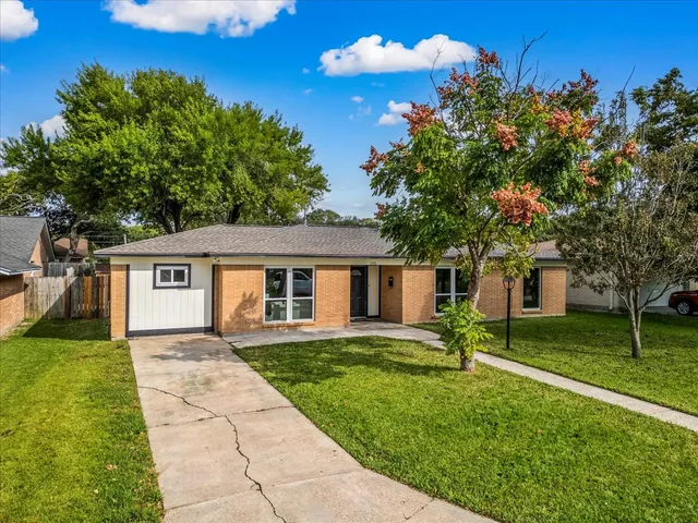 an aerial view of a house with a yard basket ball court and outdoor seating