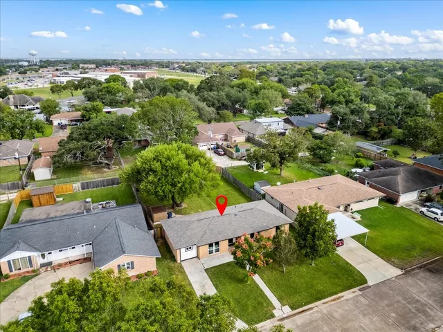 an aerial view of residential houses with outdoor space and street view