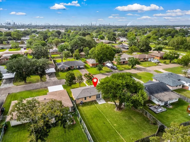 a view of a city with lots of residential buildings ocean and mountain view in back