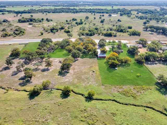 an aerial view of a houses with a yard