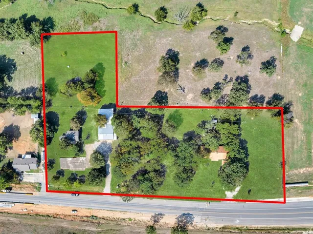 an aerial view of a house with a yard and garden