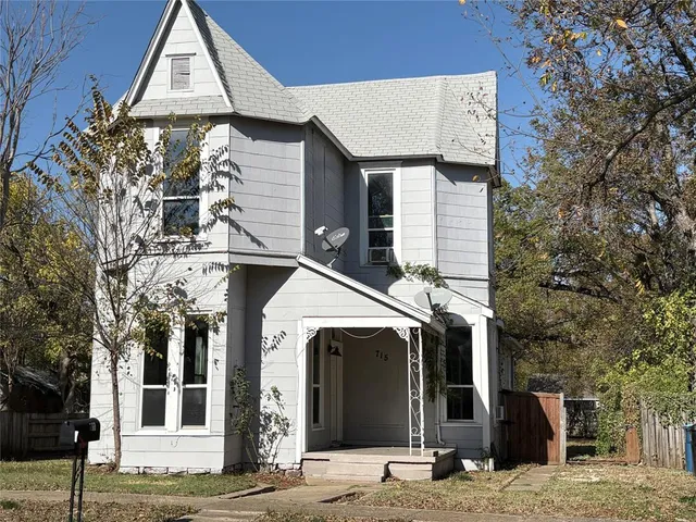 a view of a brick house with large windows