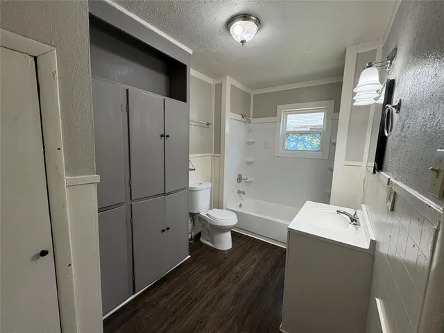 a bathroom with a sink a toilet and a large mirror