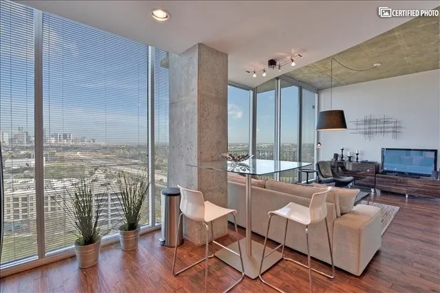 a living room with furniture and a large window