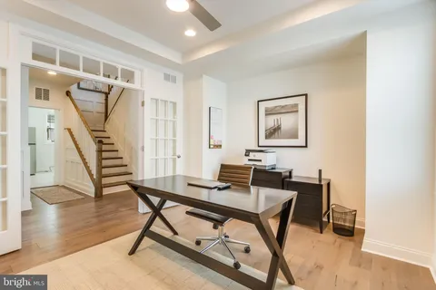 a living room with furniture a rug and a book shelf