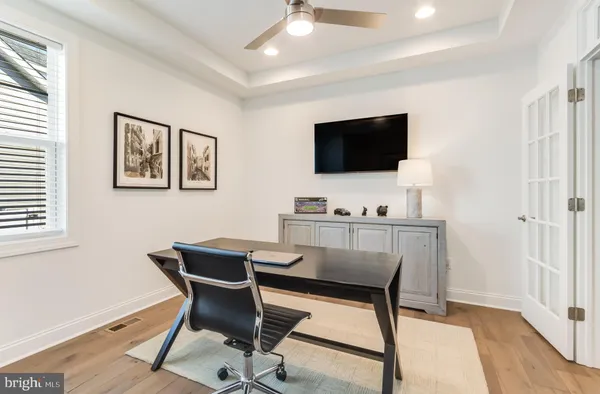a dining room with stainless steel appliances kitchen island granite countertop a table chairs and a refrigerator