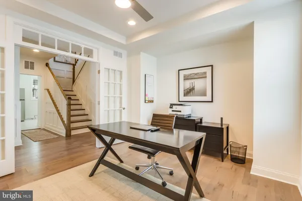 a living room with furniture a rug and a book shelf