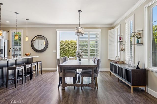 a kitchen with a table chairs sink and cabinets