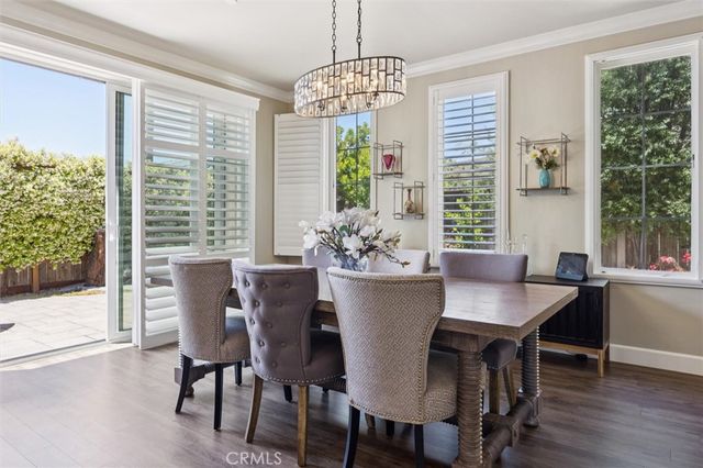 a kitchen with a granite countertop sink a window and chairs