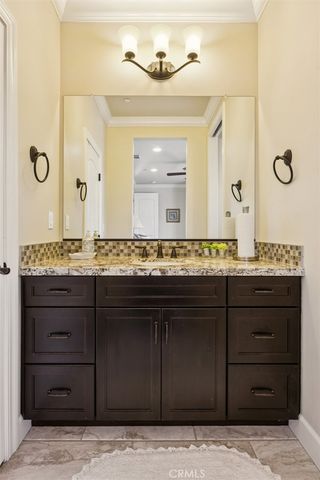 a bathroom with a double vanity sink and a mirror