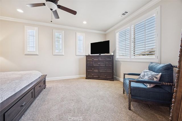 a bedroom with a bed and a painting on the wall