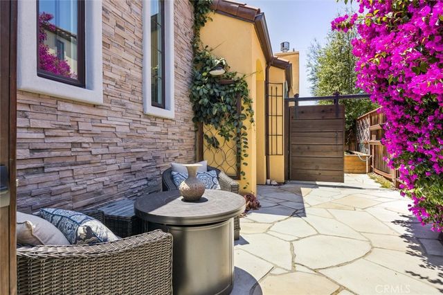 a living room with furniture a fireplace and a large window
