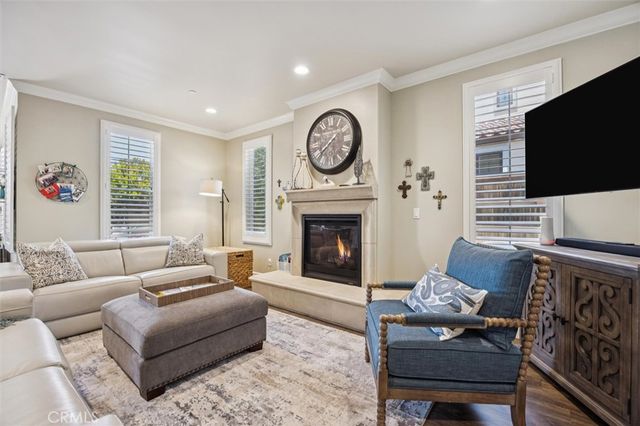 a kitchen with a table chairs and a clock on the wall