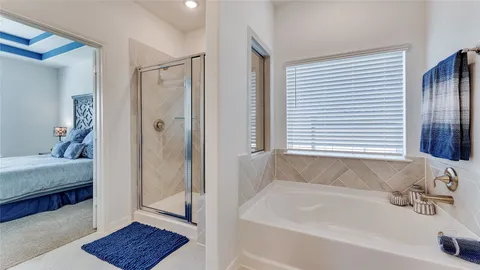 a spacious bathroom with double vanity and a shower