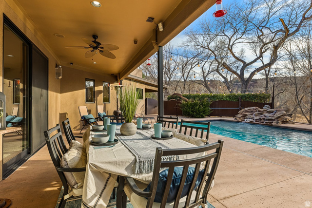 98 Bridge Road Rockville, UT 84763 - Photo 52 of 75 Fenced backyard featuring a patio area, outdoor dining space, and a ceiling fan