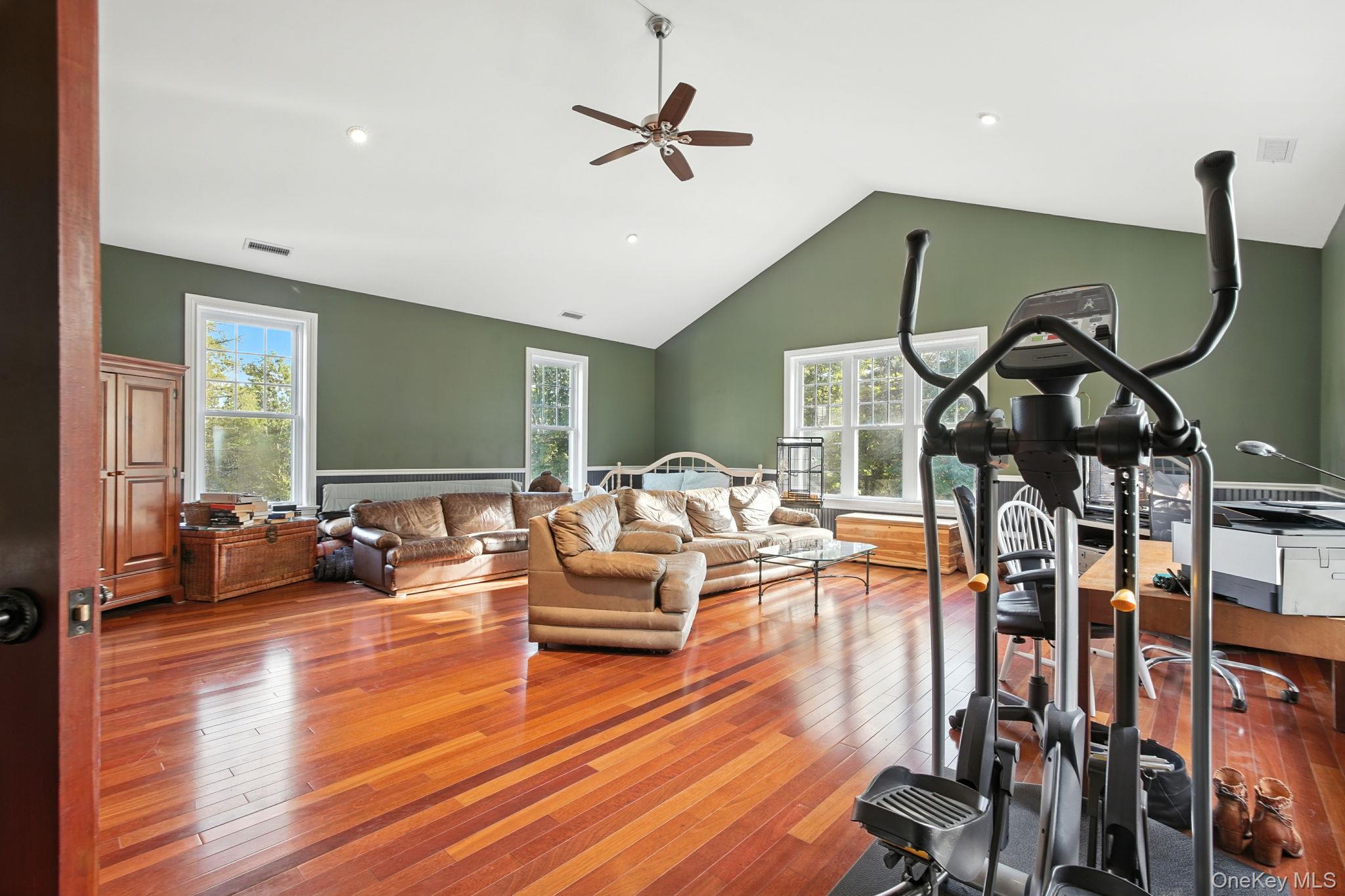 57 South White Rock Road Holmes, NY 12531 - Photo 22 of 44 a living room with furniture gym equipment and a chandelier