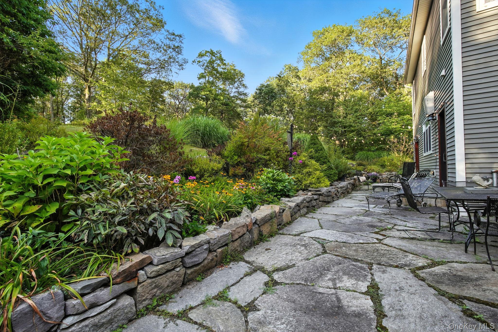 57 South White Rock Road Holmes, NY 12531 - Photo 35 of 44 a view of backyard with a table and chairs and potted plants
