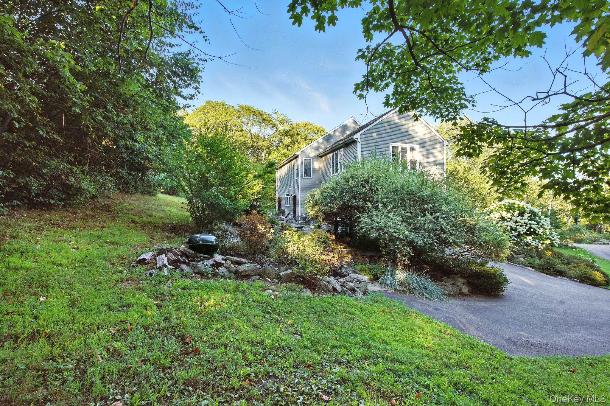 57 South White Rock Road Holmes, NY 12531 - Photo 36 of 44 a view of a backyard with plants and a bench