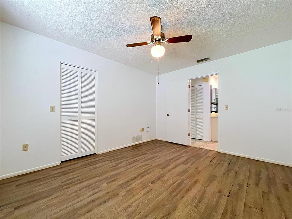 9319 Trowbridge Court New Port Richey, FL 34655 - Photo 52 of 78 wooden floor in an empty room