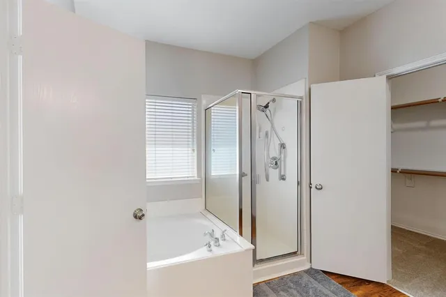 a bathroom with a bathtub and a shower