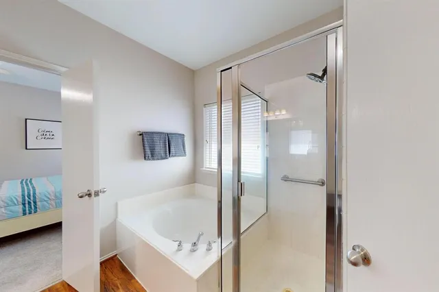 a bathroom with a tub sink and mirror