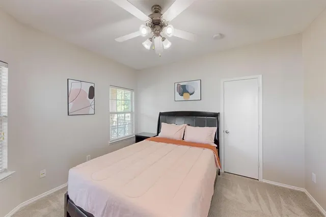 a bedroom with a large bed and a chandelier