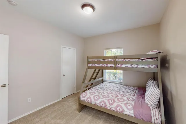 a bedroom with a bed and chair