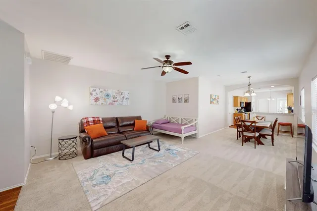 a living room with furniture and a dining table