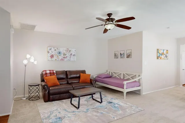 a bedroom with furniture and a rug