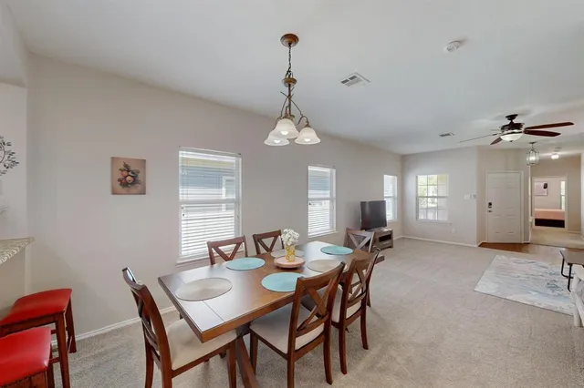 a view of a dining room with furniture and window