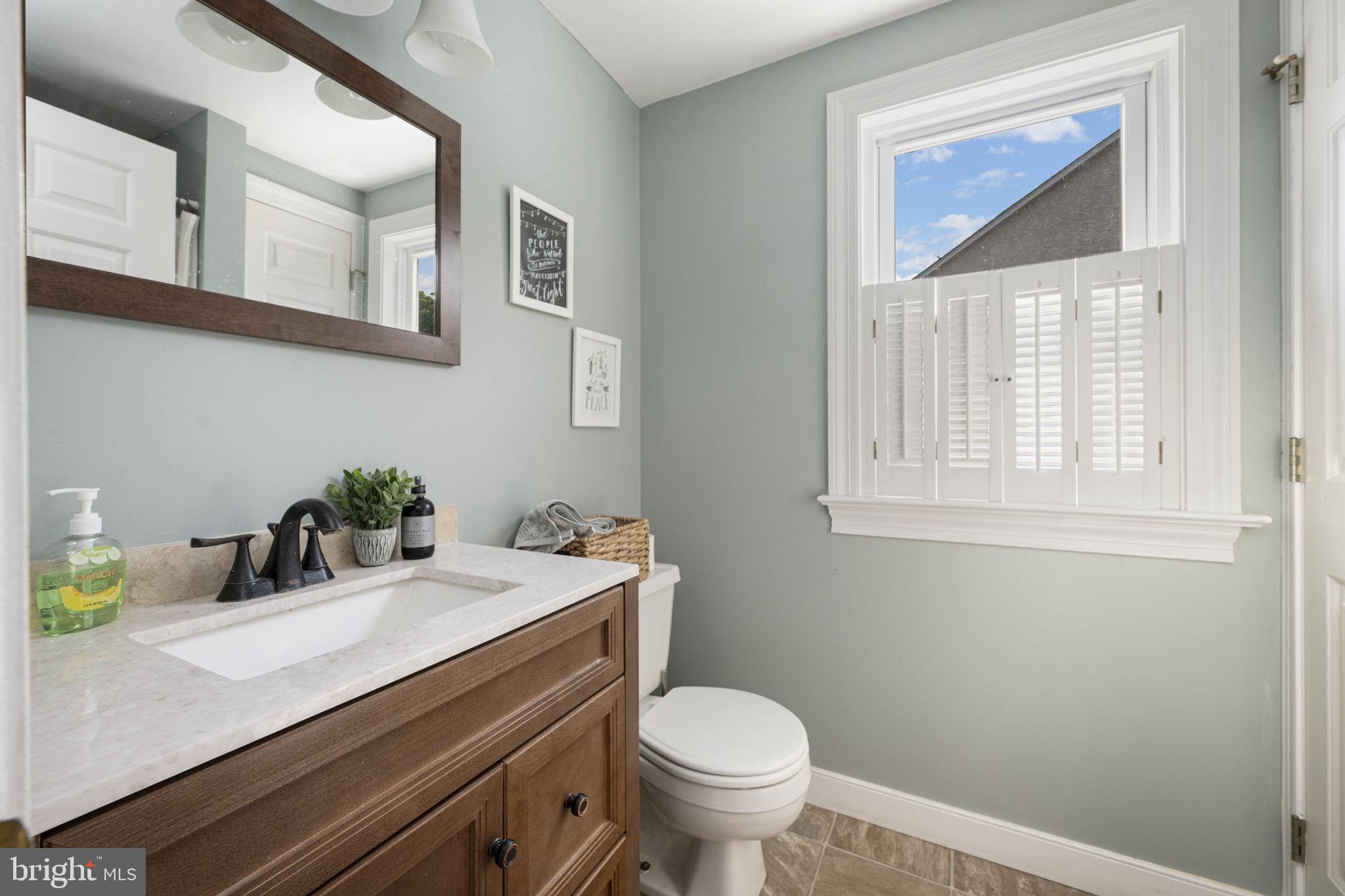 650 Fairview Road Glenmoore, PA 19343 - Photo 11 of 29 a bathroom with a sink a toilet and a window