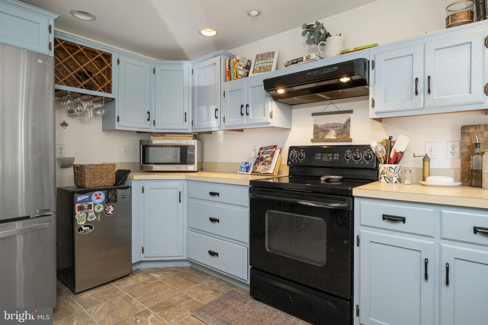650 Fairview Road Glenmoore, PA 19343 - Photo 8 of 29 a kitchen with stainless steel appliances granite countertop a stove and a refrigerator