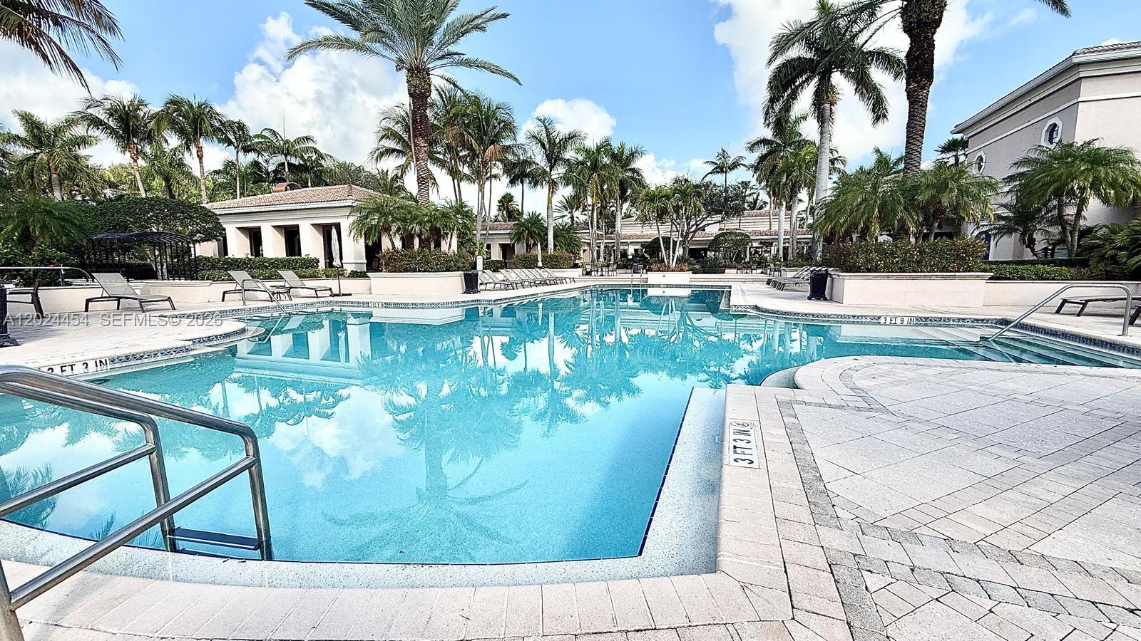 2727 Anzio Court, Unit 106 Palm Beach Gardens, FL 33410 - Photo 29 of 43 a view of a swimming pool with a sitting area
