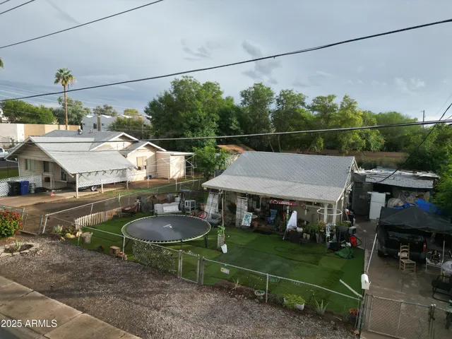a aerial view of a house with table and chairs a fire pit