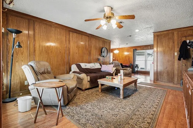 a living room with furniture a clock and a window
