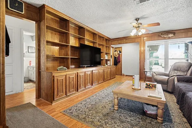 a kitchen with stainless steel appliances granite countertop white cabinets sink and a microwave