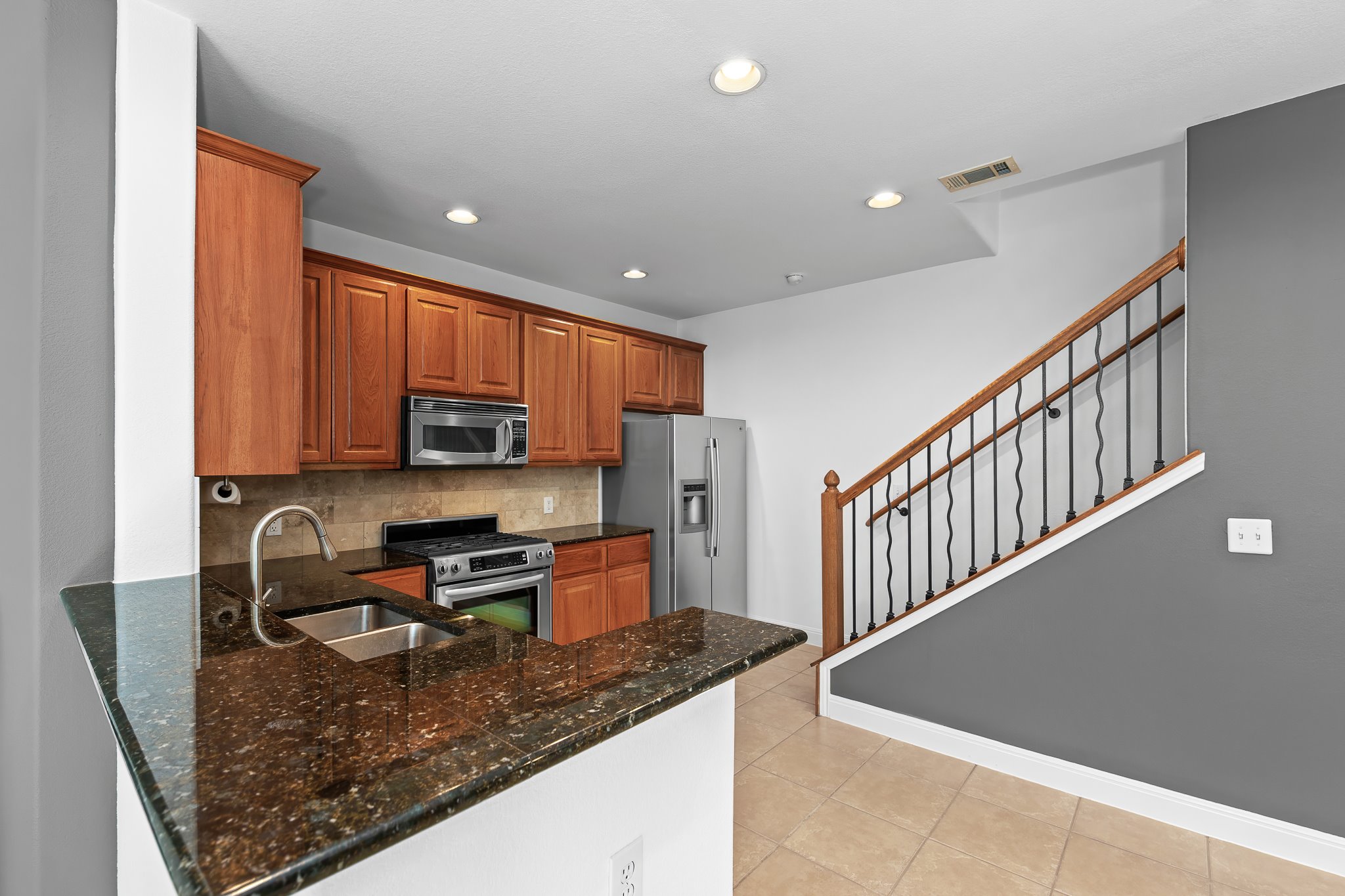 3406 Menchaca Road, Unit 28 Austin, TX 78704 - Photo 12 of 40 Kitchen with decorative backsplash, wood finish cabinets, stainless steel appliances, a peninsula, and recessed lighting