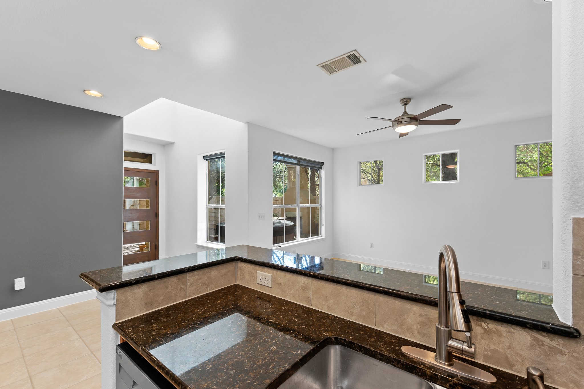 3406 Menchaca Road, Unit 28 Austin, TX 78704 - Photo 17 of 40 Kitchen featuring dark stone counters, ceiling fan, light tile patterned floors, and recessed lighting