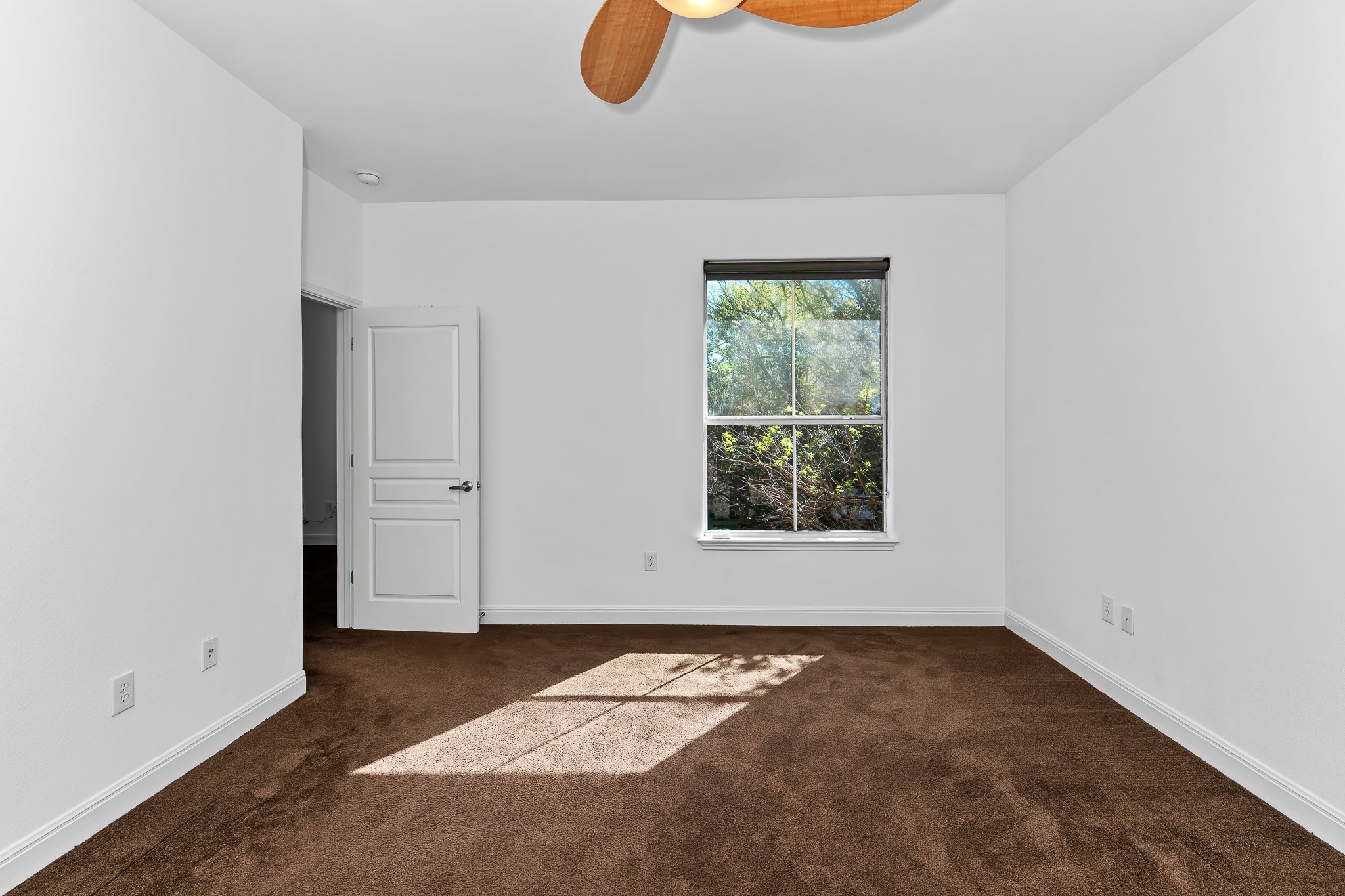3406 Menchaca Road, Unit 28 Austin, TX 78704 - Photo 27 of 40 Unfurnished room with a ceiling fan and dark colored carpet