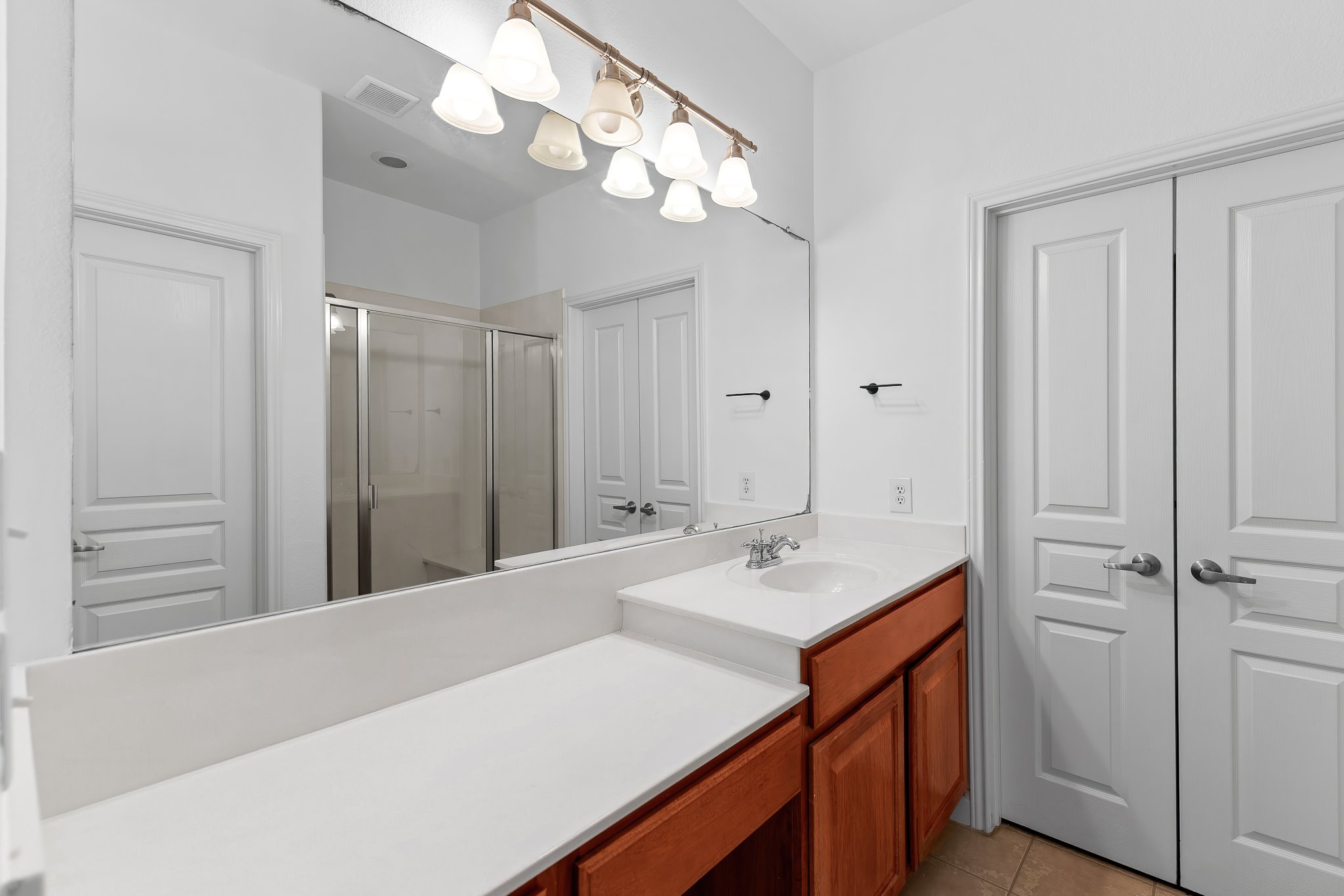 3406 Menchaca Road, Unit 28 Austin, TX 78704 - Photo 30 of 40 Bathroom with a shower stall, vanity, and light tile patterned flooring